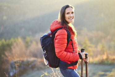Portrait of smiling woman on a hiking trip in the mountains - BSZF00980