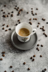 Cup of espresso and scattered coffee beans - AFVF02355