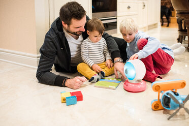 Father and sons playing with toys on floor - ISF20683
