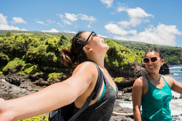 Hikers enjoying sunshine on coast of Waipipi Trail, Maui, Hawaii - ISF20753