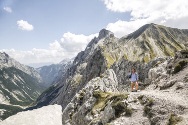 Austria, Tyrol, woman on a hiking trip in the mountains - FKF03302