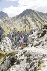 Austria, Tyrol, woman on a hiking trip in the mountains - FKF03303