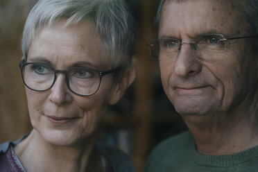 Confident senior couple looking out of window - KNSF05523