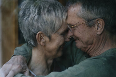 Affectionate senior couple embracing at home - KNSF05525