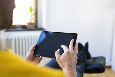 Close-up of man using tablet at home - SBOF01722