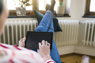 Close-up of woman using tablet at home - SBOF01737