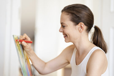 Profile of smiling woman painting - DIGF05846
