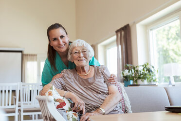 Portrait of smiling senior woman and healthcare worker at nursing home - MASF11148