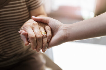 Cropped image of home caregiver holding hand of senior woman - MASF11160