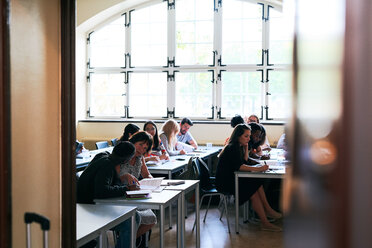 Multi-ethnic students sitting at desks during language class - MASF11237