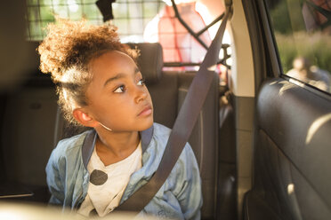 Girl looking through window while sitting in electric car - MASF11430