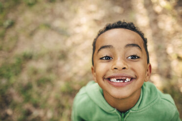 High angle view of smiling boy with gap toothed in park - MASF11441