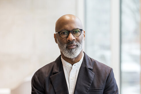 Portrait of bald mature businessman with grey beard wearing glasses - FMKF05390