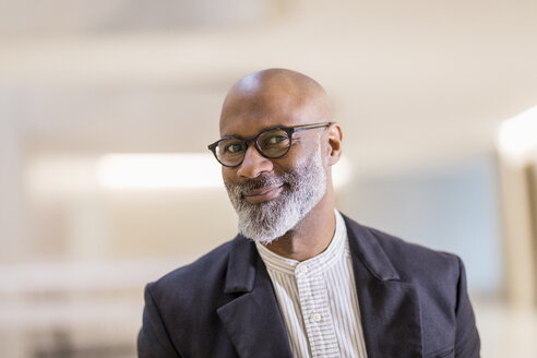 Portrait of bald mature businessman with grey beard wearing glasses - FMKF05402