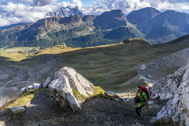 Italy, Veneto, Dolomites, San Pellegrino Pass, mountaineer walking near Paradiso mountain hut - LOMF00807
