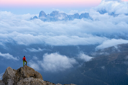 Italy, Veneto, Dolomites, Alta Via Bepi Zac, mountaineer standing on Pale di San Martino mountain at sunset - LOMF00826