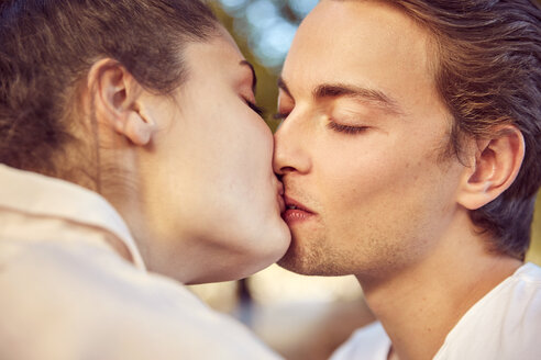 Junges verliebtes Paar, das sich im Freien küsst - JHAF00055