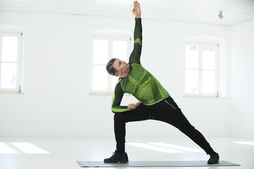 Mann bei seinem Fitnessprogramm, der Yoga-Posen übt - MAEF12819