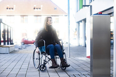 Young woman in wheelchair in the city - SGF02255