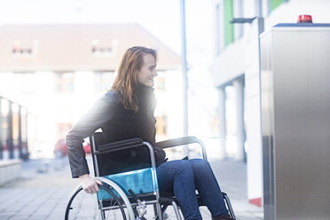 Young woman in wheelchair in the city - SGF02256