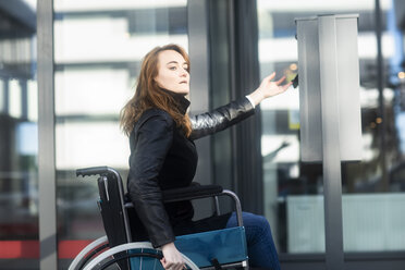 Young woman in wheelchair in the city - SGF02257