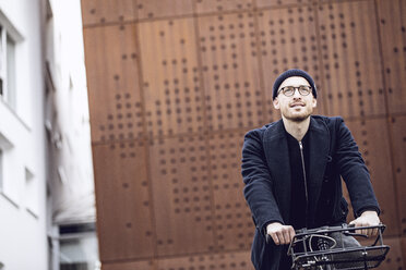 Man with beanie hat riding his bicycle - MCF00022