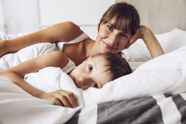 Mother and son cuddling in bed - MCF00044