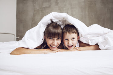 Mother and son cuddling under blanket, laughing - MCF00046