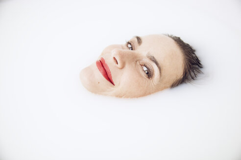 beautiful woman relaxing in a milk bath - MCF00055