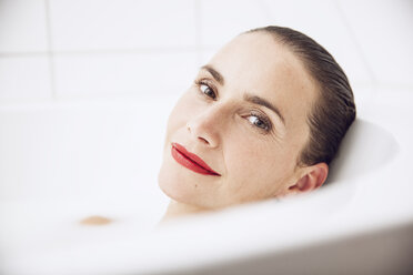 beautiful woman relaxing in a milk bath - MCF00056