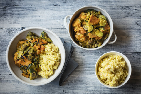 Millet with creamy vegetables, courgette, sweet potatoes and mushrooms stock photo