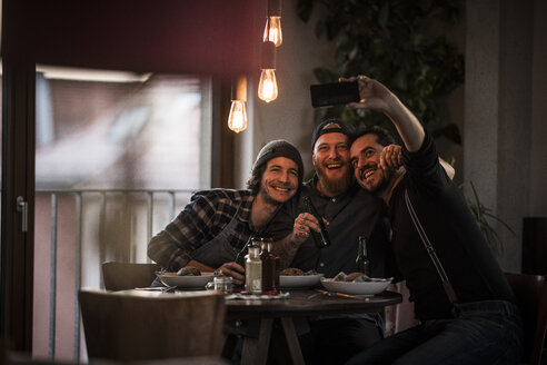 Friends eating what they have cooked and taking selfies - MJRF00068