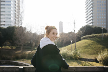 Portrait of smiling young woman in the city - JRFF02680