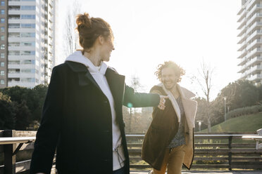 Happy couple running in the city - JRFF02689