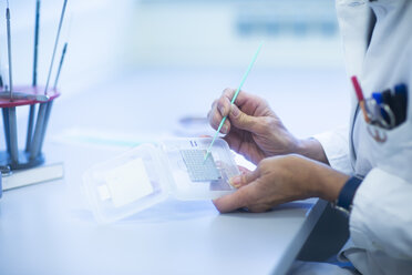 Lab technician preparing sample - SGF02260