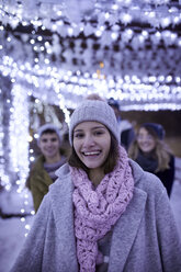 Portrait of happy young woman in winter decoration - ZEDF01909