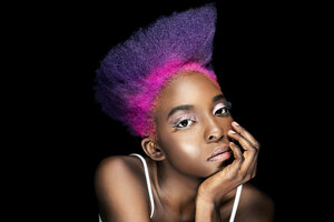 Portrait of eccentric young woman with pink and purple dyed hair in front of black background - DMOF00138