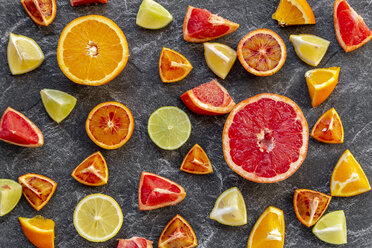 Sliced citrus fruits on slate - SARF04124