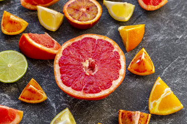 Sliced citrus fruits on slate - SARF04125