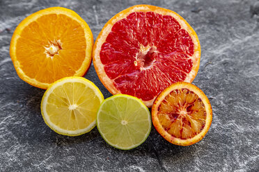 Sliced citrus fruits on slate - SARF04126