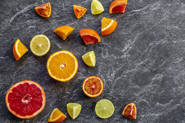 Sliced citrus fruits on slate - SARF04127