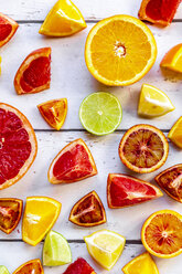 Sliced citrus fruits on white wood - SARF04129