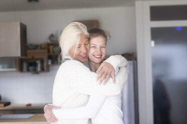 Portrait of happy mother embracing adult daughter at home - SGF02292