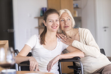 Mother with daughter in a wheelchair - SGF02330