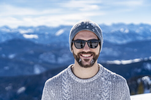 Deutschland, Bayern, Brauneck, Porträt eines lächelnden Mannes im Winter in den Bergen - DIGF05929
