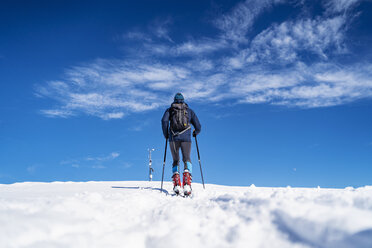 Germany, Bavaria, Brauneck, man on a ski tour in winter in the mountains - DIGF05954