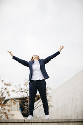 Happy businesswoman spreading her arms in the city - JRFF02751