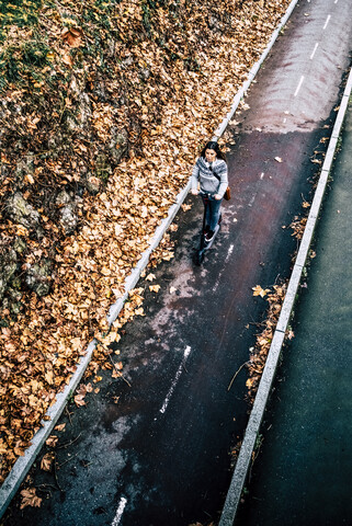 Young woman riding electric scooter on the street stock photo