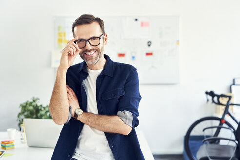 Porträt eines lächelnden Geschäftsmannes im Büro - BSZF01019