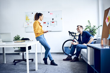 Two colleagues with tablet meeting in office - BSZF01025